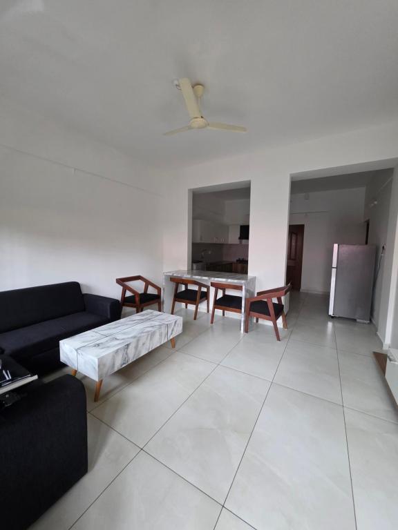 a living room with a couch and a table at Agarta towers in Perinād