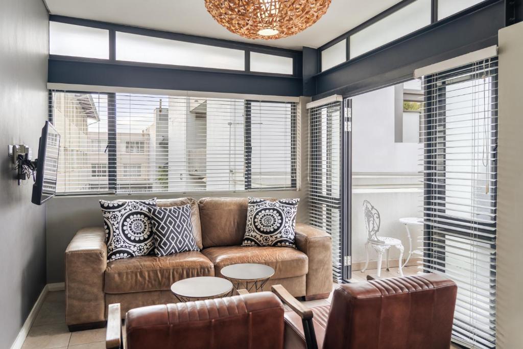 a living room with a couch and a table at Avemore Eikehoff No 26 in Stellenbosch