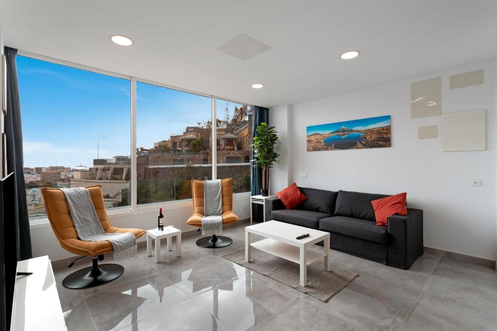 a living room with a couch and chairs at Modern Loft Las Palmas views 2 suit in Ciudad Jardín