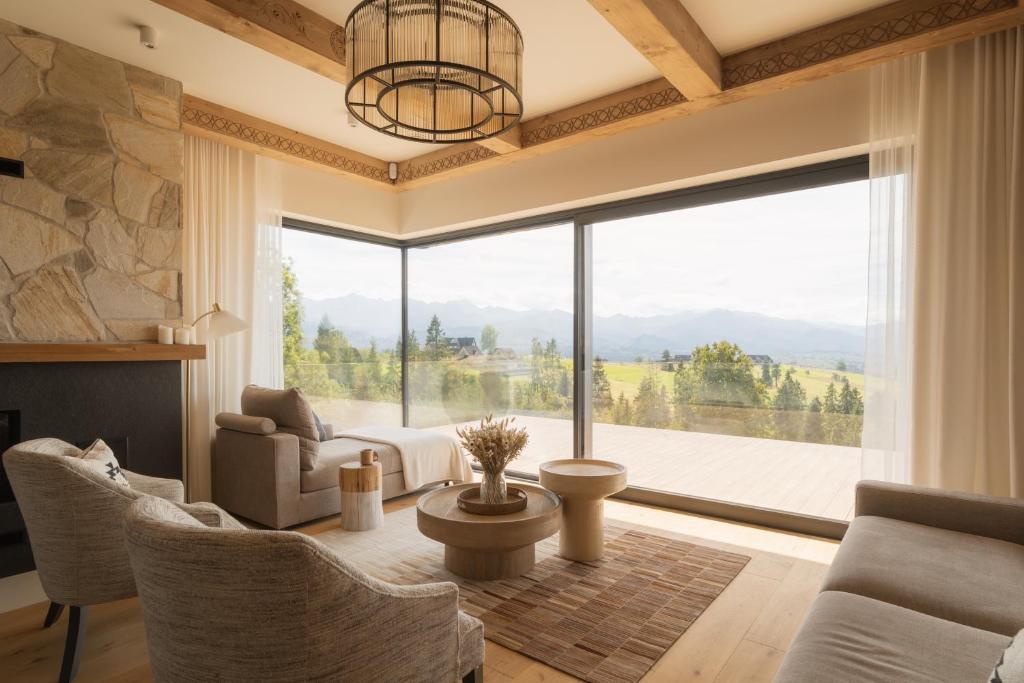 a living room with a large window with a view at Villa Matygówka in Gliczarów Górny