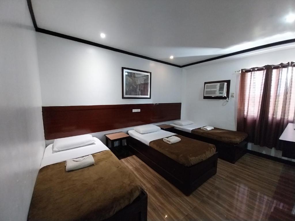 Ένα ή περισσότερα κρεβάτια σε δωμάτιο στο Wayfarer Pension House, Dormitory, and Fast Food