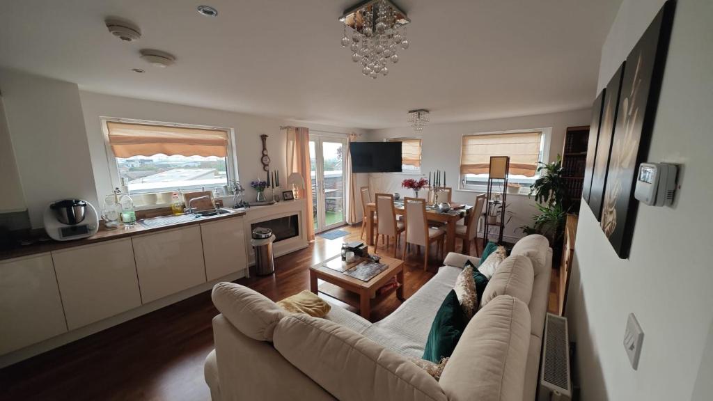 a living room with a couch and a dining room at The Bridge in Dartford