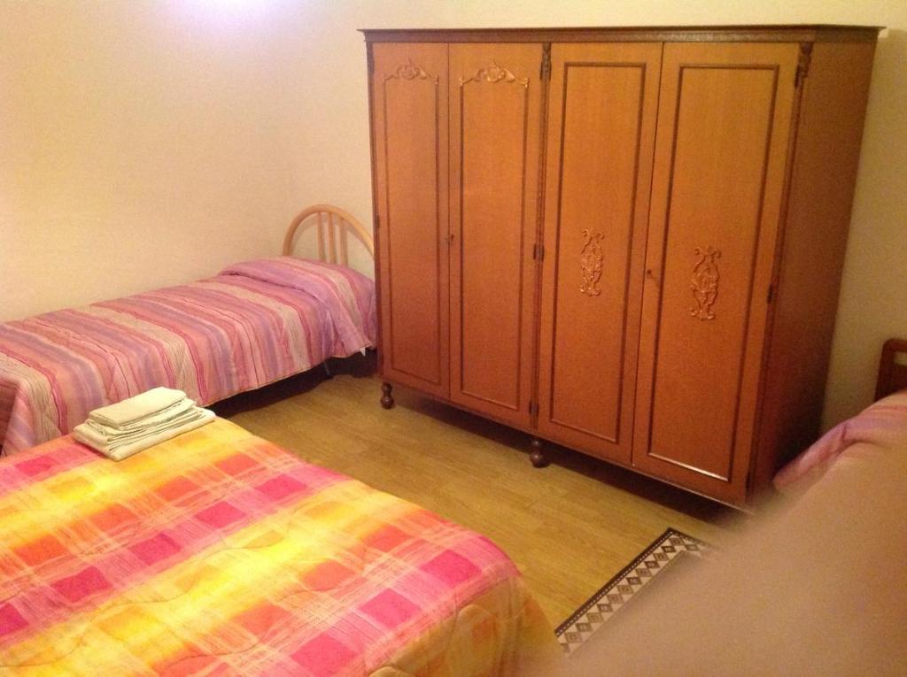 Łóżko lub łóżka w pokoju w obiekcie Palazzina Rosa