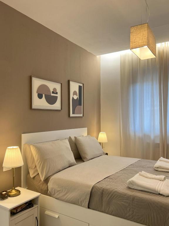 a bedroom with a white bed and a white table at La Terrazza di Luca in Tavernelle