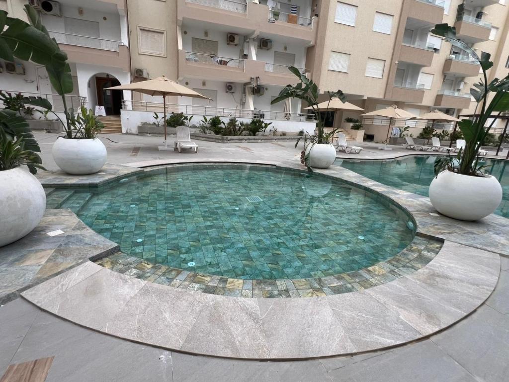 a large swimming pool in the middle of a building at chott meriem cozy apartment in Akouda