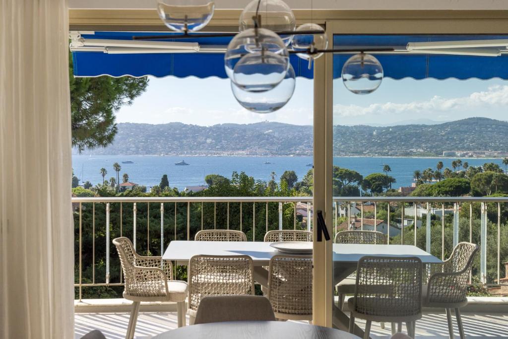 a dining room with a view of the ocean at Riviera luxury estates in Antibes