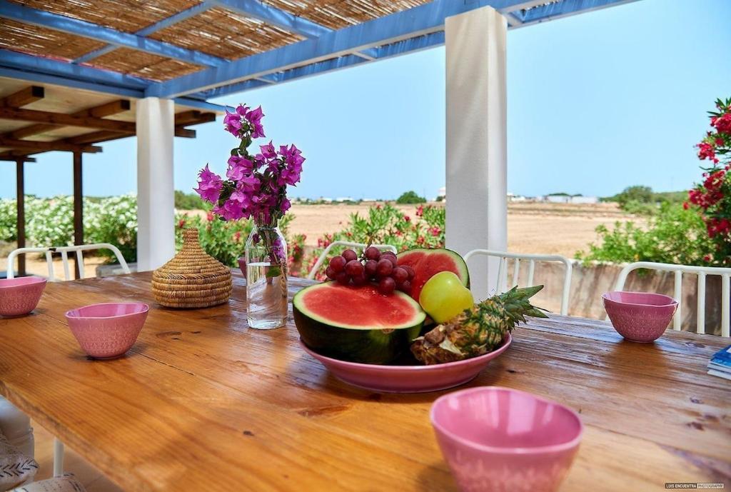 a wooden table with a bowl of fruit on it at Casa Codol in Illes Balears