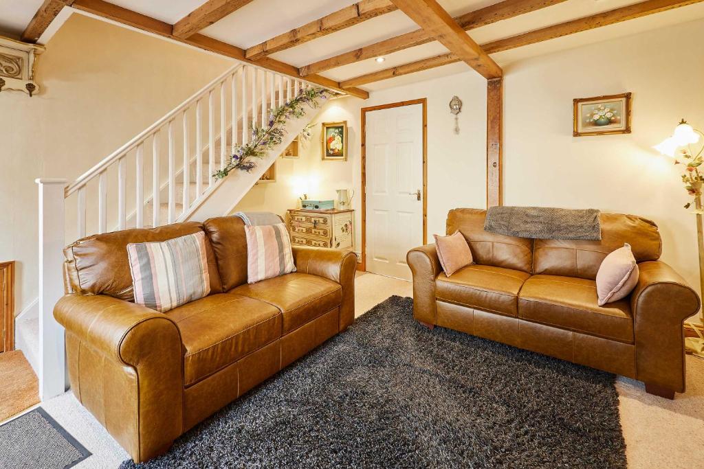 ein Wohnzimmer mit einer Couch und einem Sessel in der Unterkunft Host & Stay - Dairy Cottages in Masham