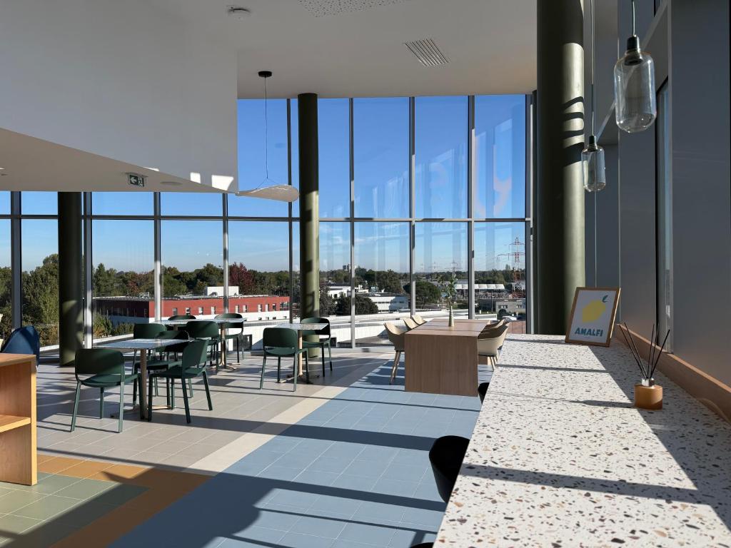 a rendering of the lobby of a building with tables and chairs at Sweetly Bordeaux Mérignac in Mérignac