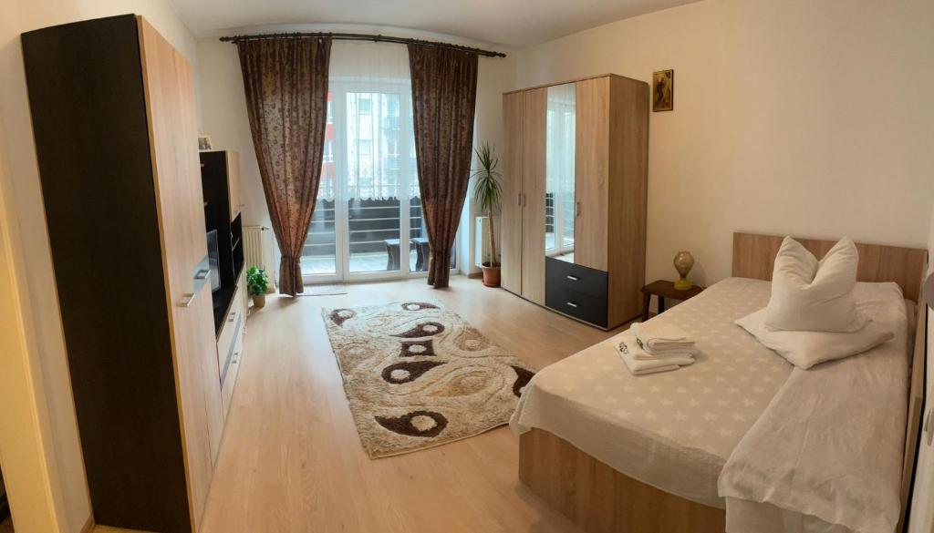 a bedroom with a bed and a large window at Avantgarden 3 Brasov by BuySellRent in Braşov
