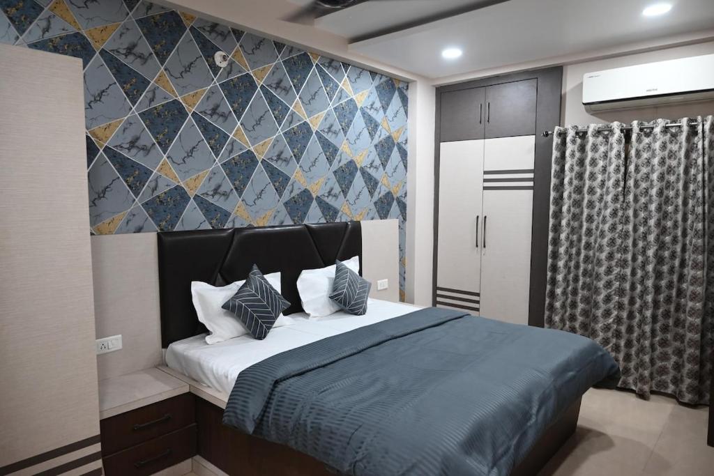 a bedroom with a large bed with blue sheets and pillows at Shivalay - By Safarnama Stays - Near Kashi Vishwanath in Varanasi