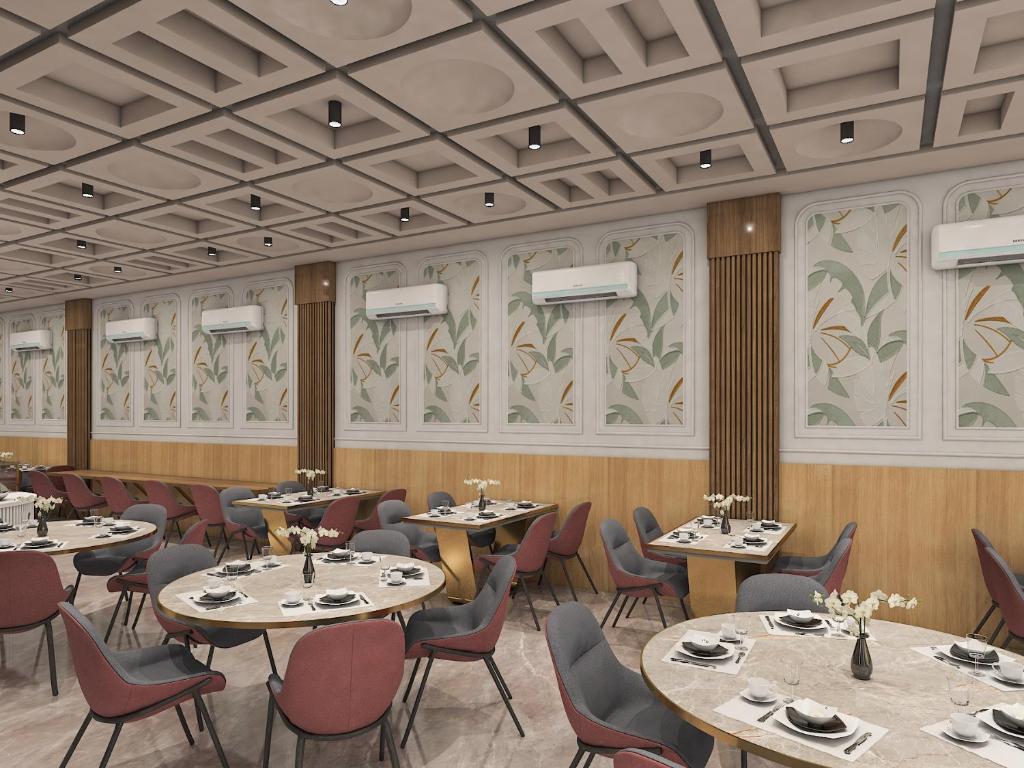 a restaurant with tables and chairs in a room at Radiant Sky Hotel in Kuchāman City