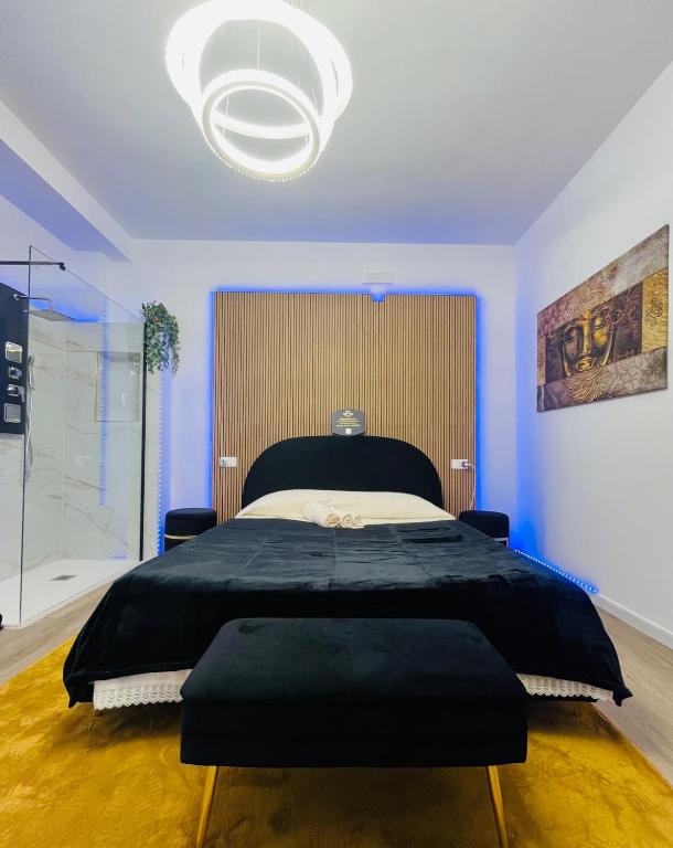 a bedroom with a large bed and a large chandelier at Your Exclusive Apulian Suite Near Matera in Ginosa