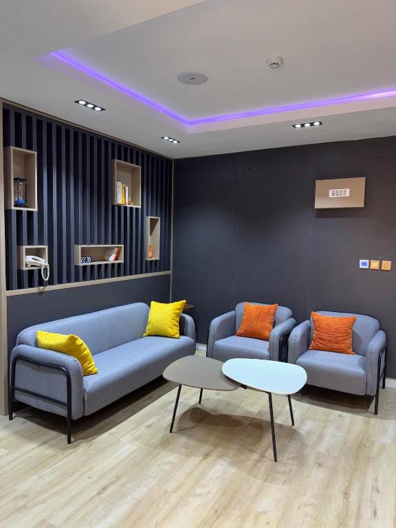 a waiting room with two couches and a table at Sapphire Suite in Abuja