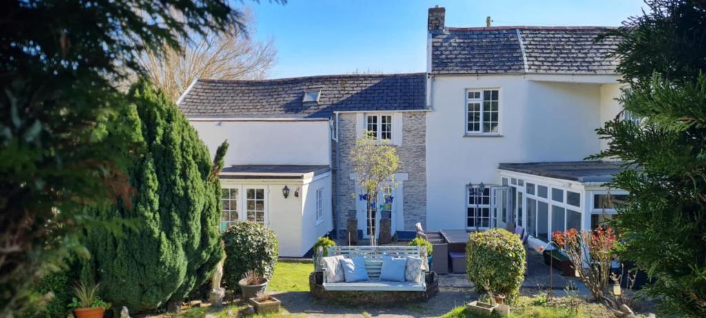 a white house with a garden in front of it at Charming cottage in Pilton-newly renovated in Barnstaple