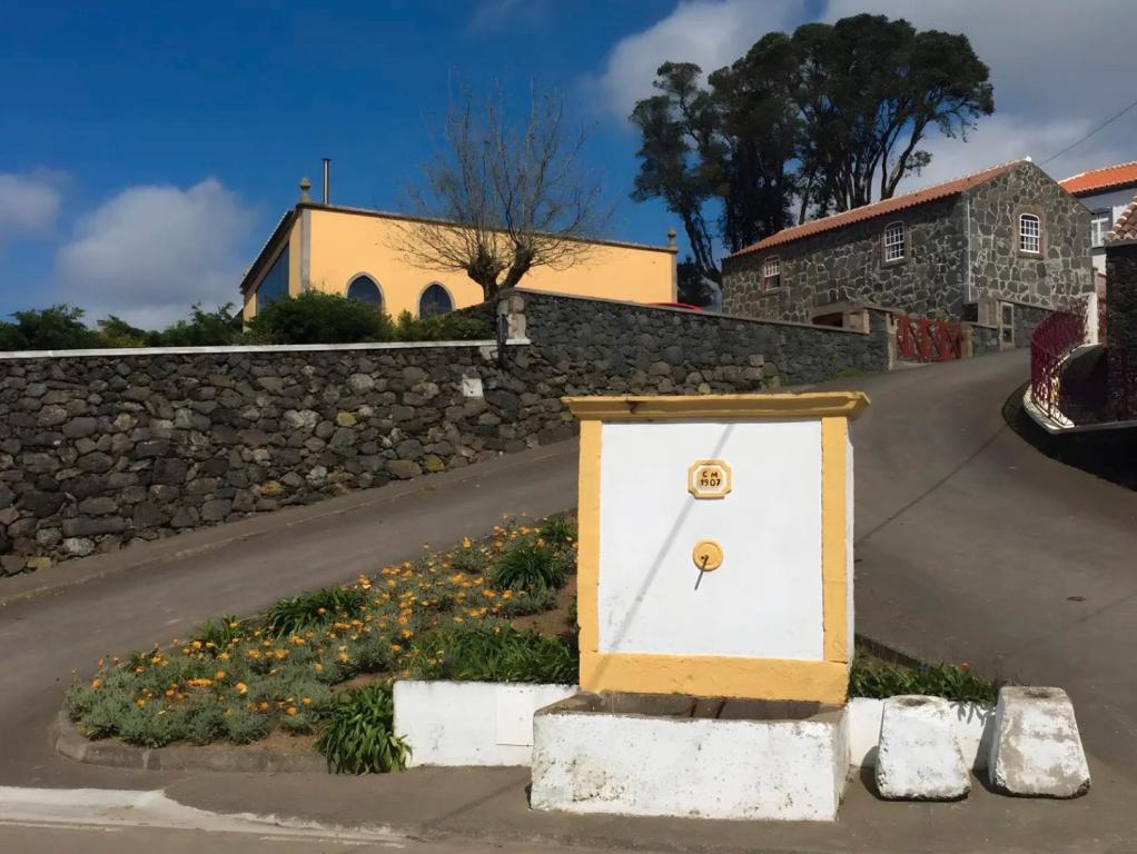 a white door sitting on the side of a road at Serreta Island Home in Serreta