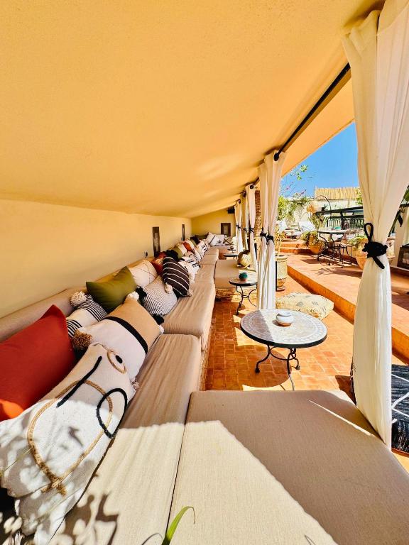 une longue rangée de canapés assis dans une pièce dans l'établissement Riad Dar Beldia and Spa, à Marrakech