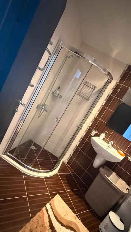 a bathroom with a shower and a sink at Atlantis Resort in Burgas City