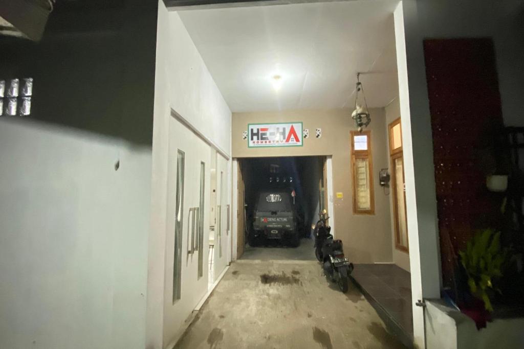 a dark hallway with a car parked in a garage at OYO 94839 He-ha Homestay Syariah in Kejajar