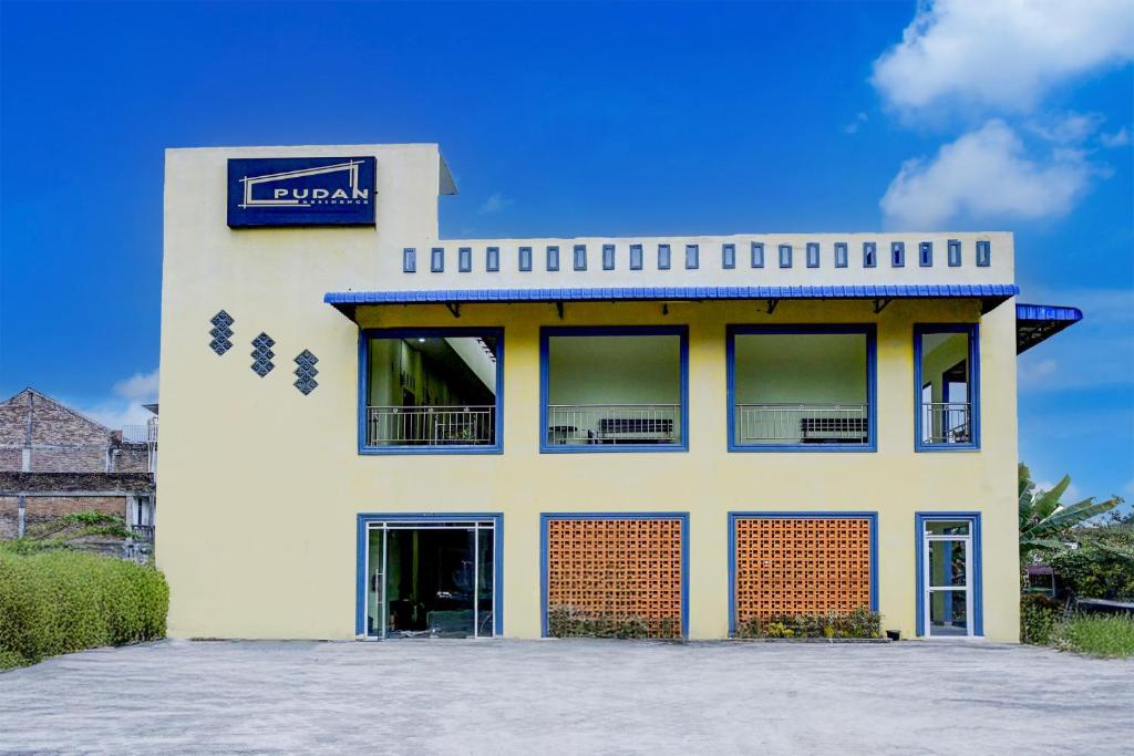 a building with a sign on the side of it at Dancenter Pudan Residence in Balige