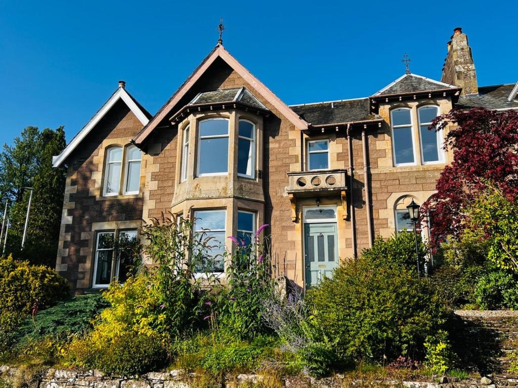 an old brick house on a sunny day at Dungora House in Crieff
