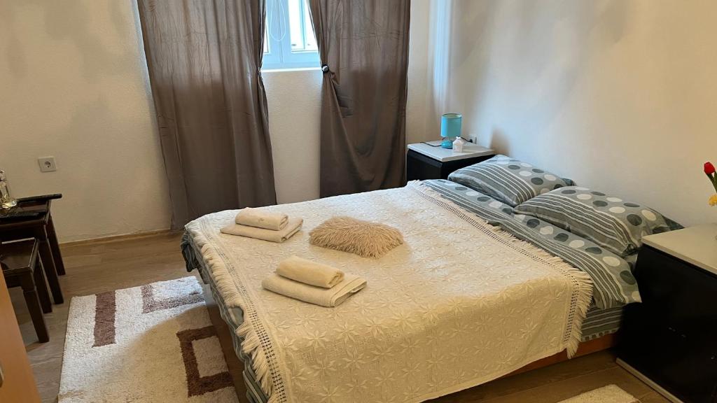 a bedroom with a bed with two towels on it at Old Town Sidro Apartment in Sarajevo