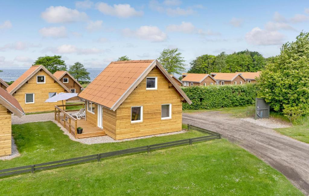 a group of wooden homes with a driveway at Lovely Home In Tranekær in Tranekær