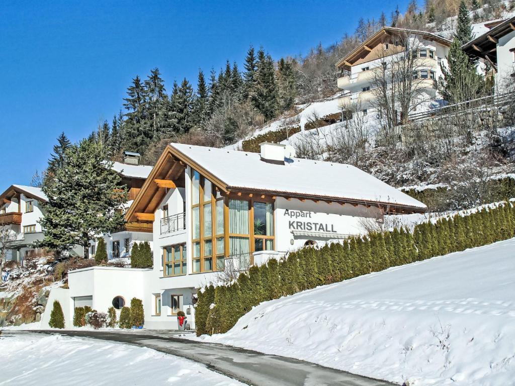 a building on a snow covered hill with a road at Apartment Kristall-2 by Interhome in Fendels