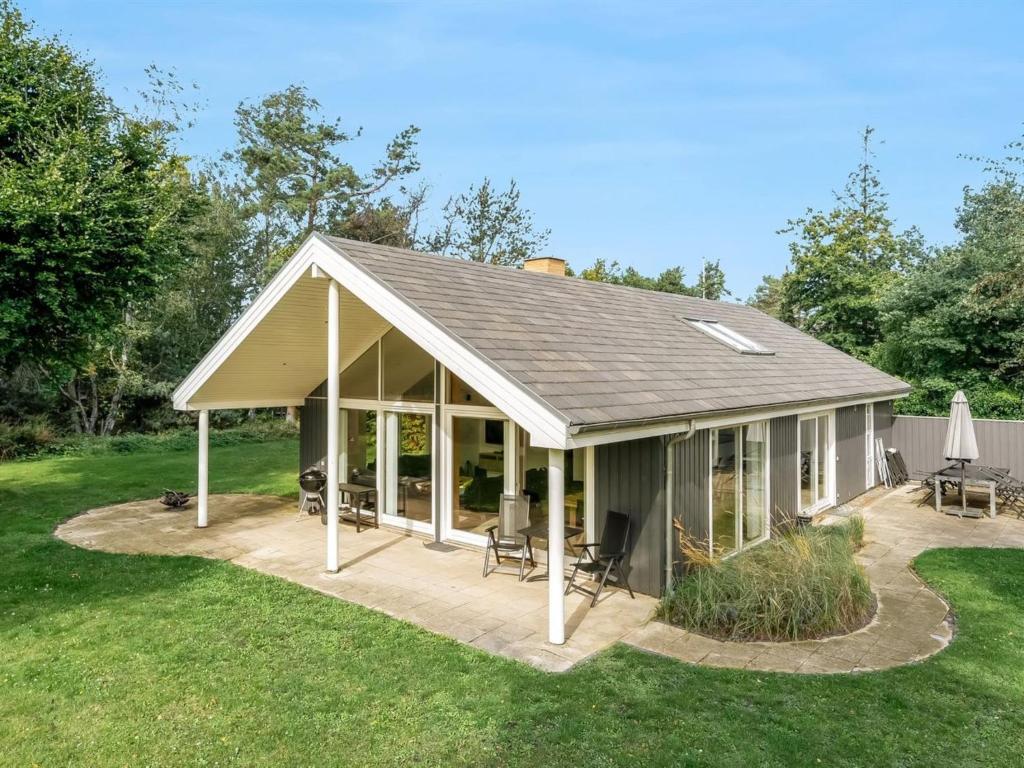 a large screened in porch with a roof at Holiday Home Talitha - 40m from the sea by Interhome in Marielyst