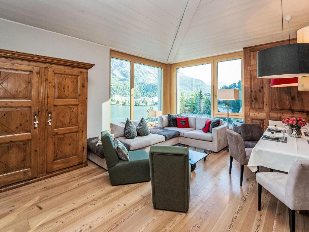 a living room with a couch and a table at Apartment Chesa Spuonda Verde 2-5 by Interhome in St. Moritz