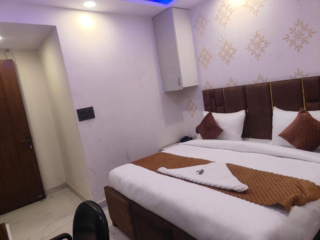 a bedroom with a large bed in a room at NP International Govindpuri Metro in New Delhi