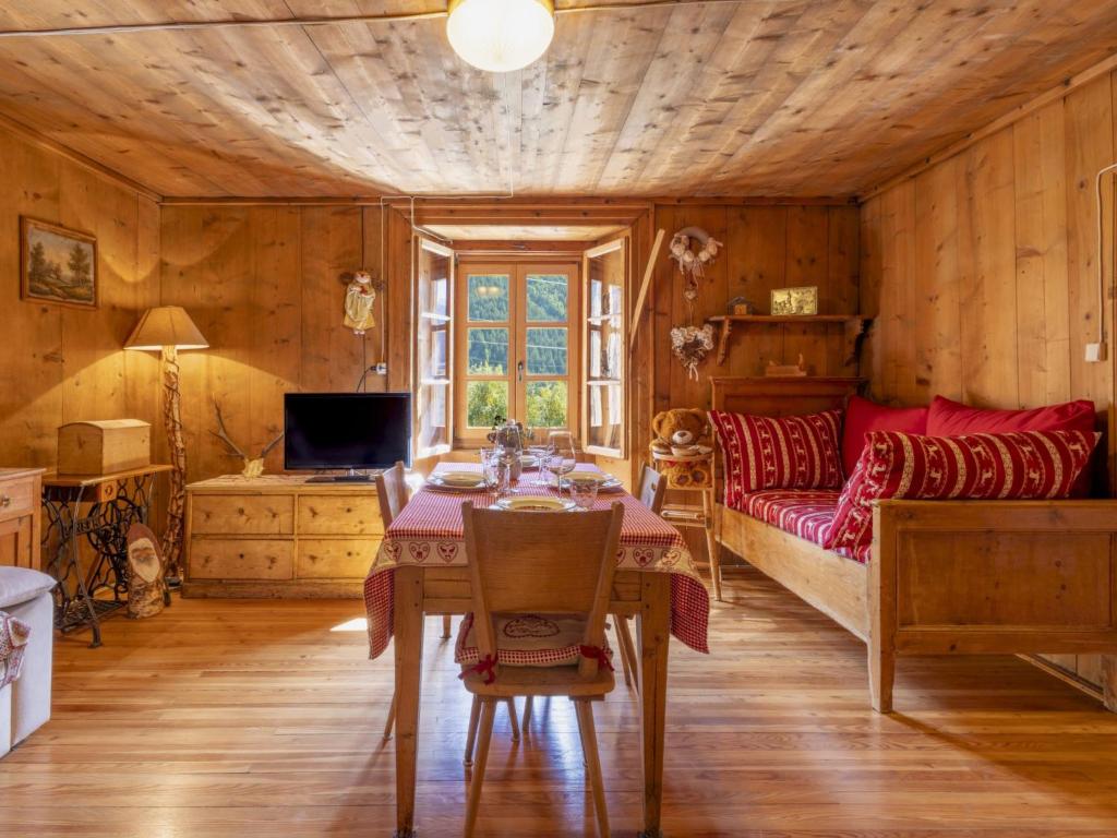 a room with a table and a bed and a couch at Apartment Pozzaglio Mountain Home by Interhome in Valdisotto