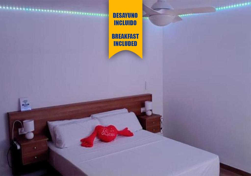 a bedroom with a bed with red pillows on it at Apartalux San Pedro Ático de Luna in San Pedro del Pinatar