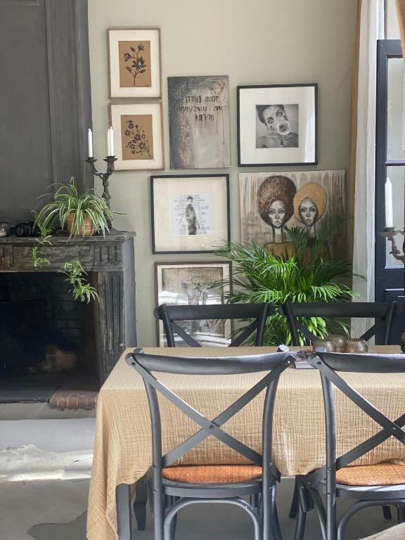a dining room with a table and some pictures on the wall at Dreamhome B&B Limoux in Limoux