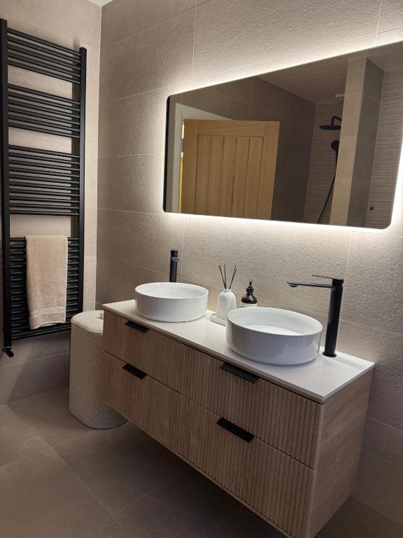 a bathroom with two sinks and a large mirror at Riversdale Road Tyrone Omagh Fermanagh in Drumquin