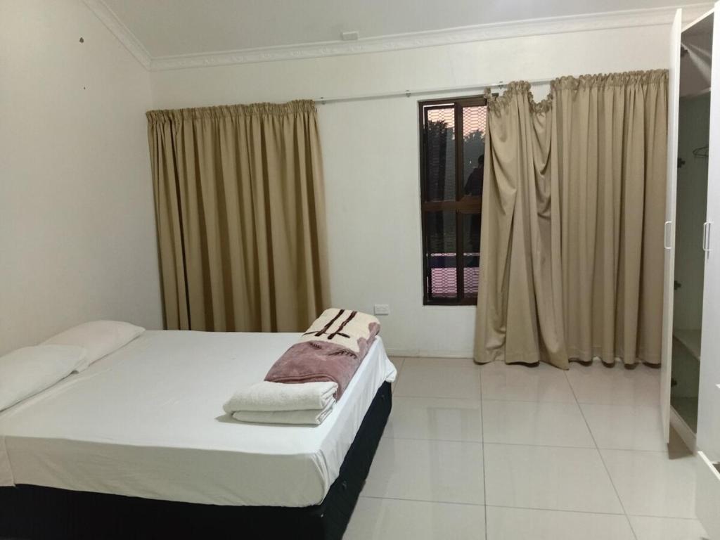a bedroom with a bed and a window at Large 4 Bedroom 7 Bed Villa in Sonaisali Rd, Nadi in Nadi
