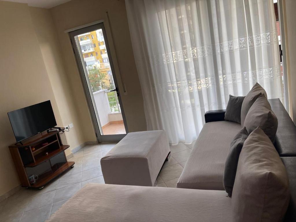 a living room with a couch and a tv at 1Bedroom Apt in Tirana - Close to Scanderbeg Square in Tirane