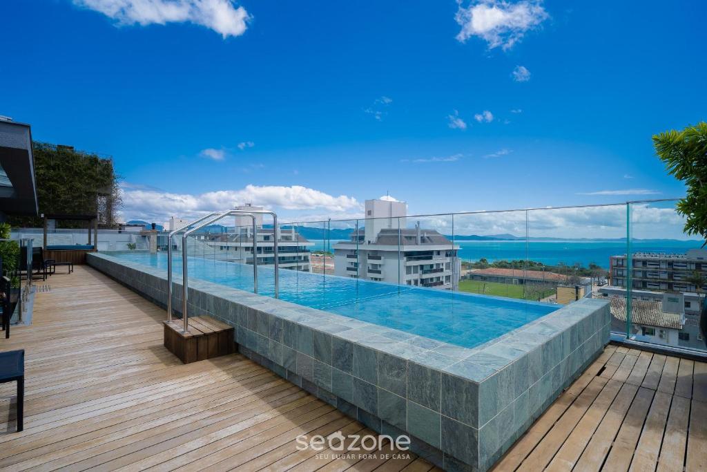 a swimming pool on the roof of a building at Apt w/ balcony and grill 220m from the Sea ALB0201 in Florianópolis