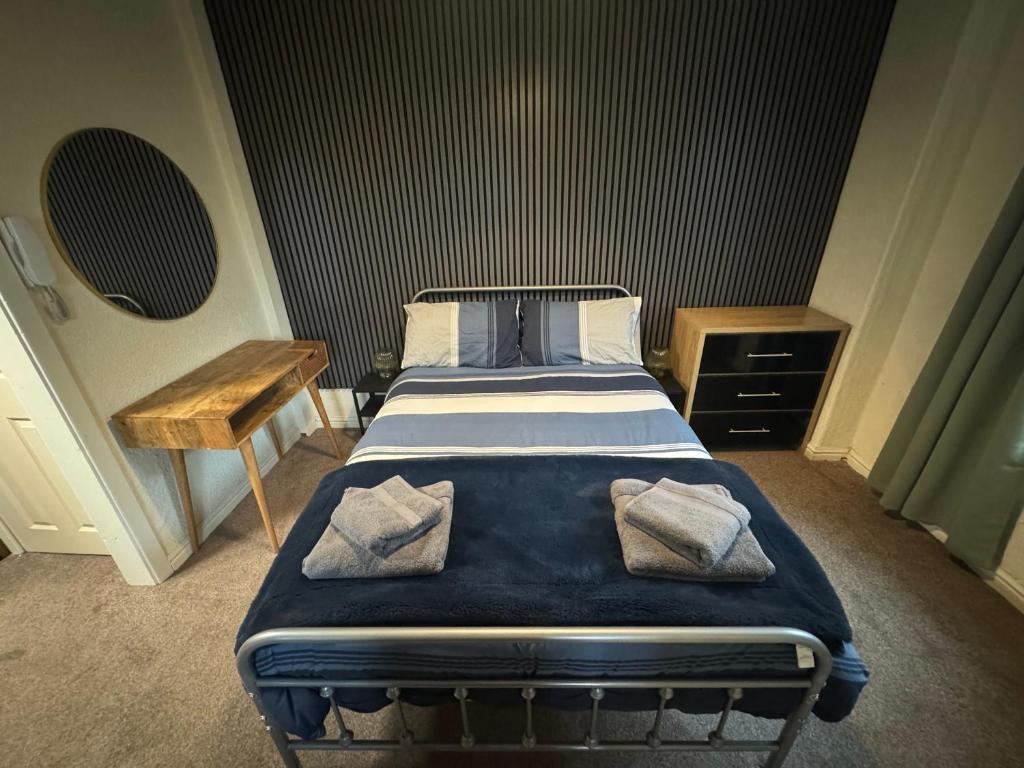 a bedroom with a bed with two pillows on it at Reads Avenue 1 Bed Apartment - Next To H&A Social Club - Minutes from Winter Gardens & Town Centre! in Blackpool