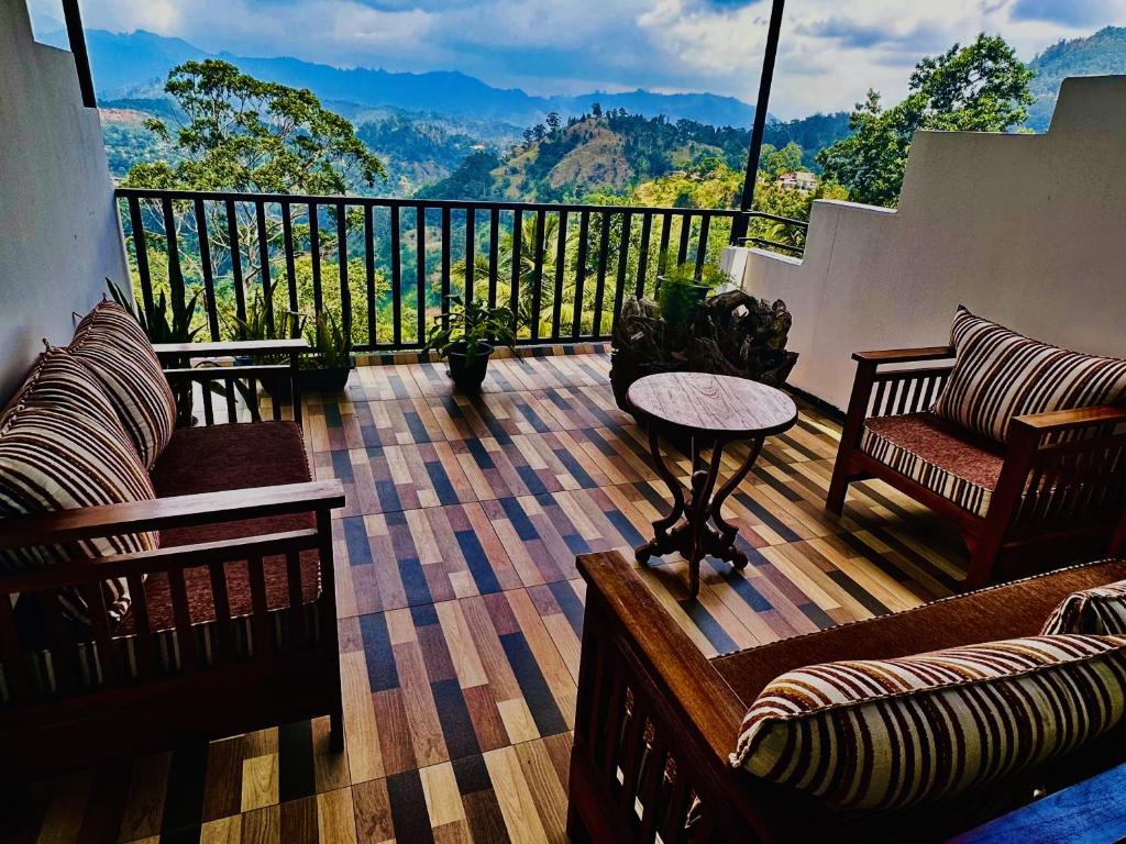 a room with a balcony with couches and a table at Shining Green View in Ella