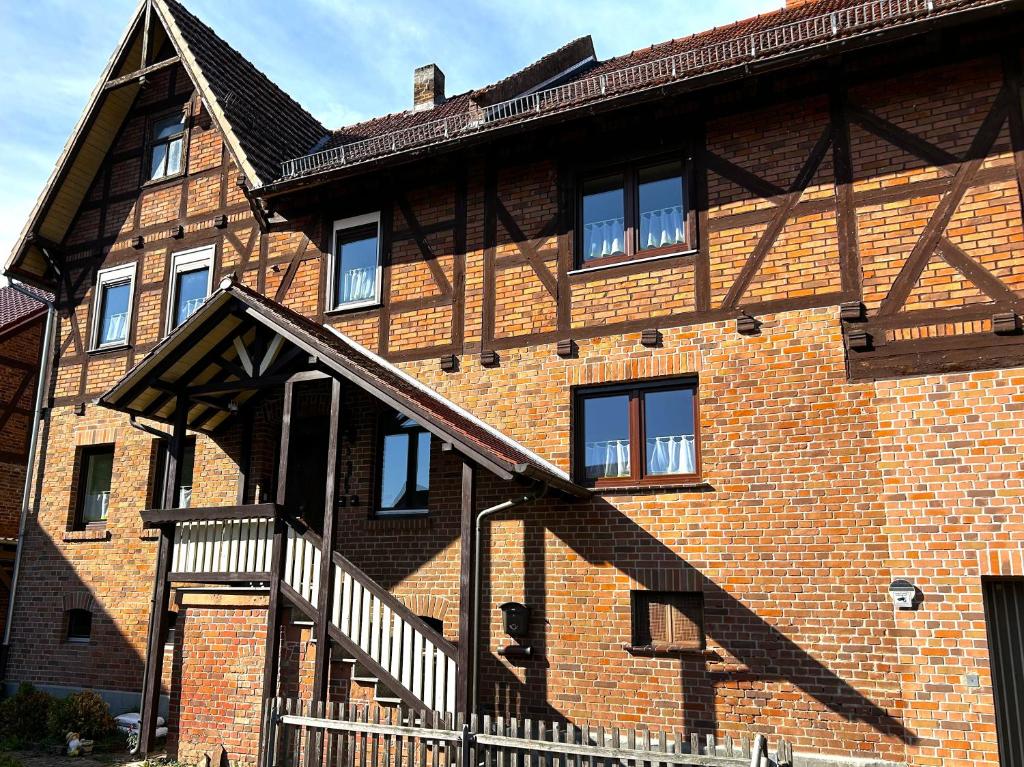 a brick building with a staircase on the side of it at FEWO Unterm Stein - Ganzes Haus - 5 Schlafzimmer in Alheim