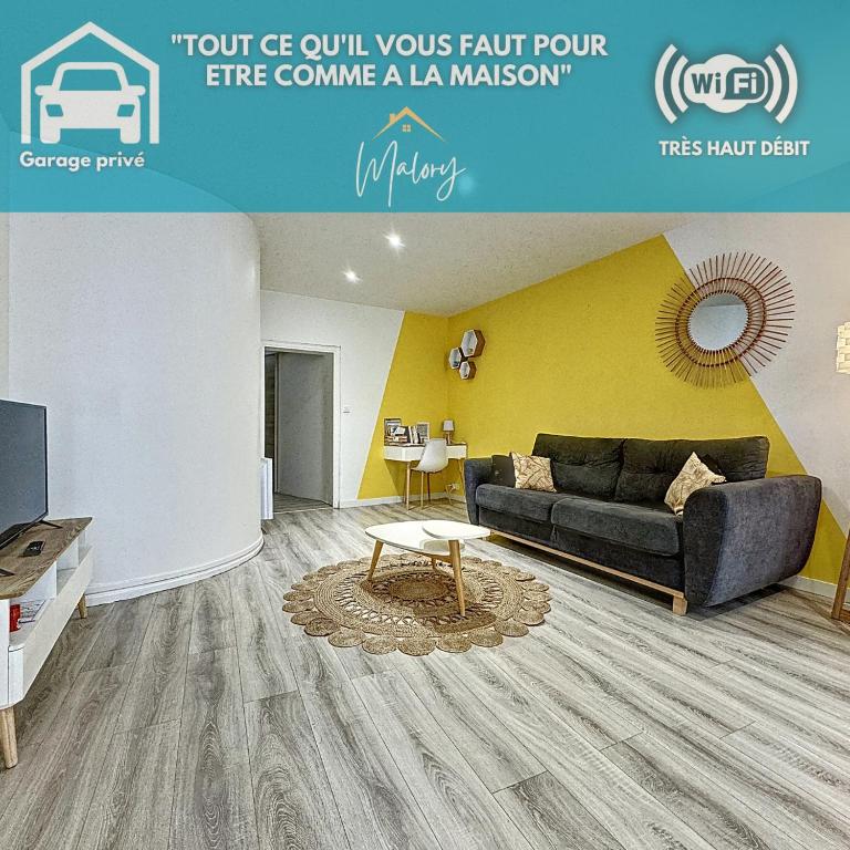 a living room with a couch and a table at Confort, wifi et garage in Millau