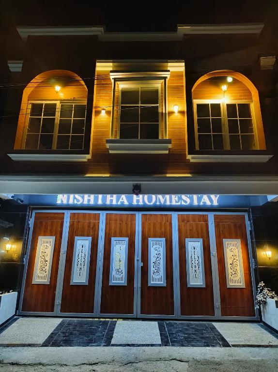 a building with signs on the front of it at Nishtha Homestay in Lohaghāt