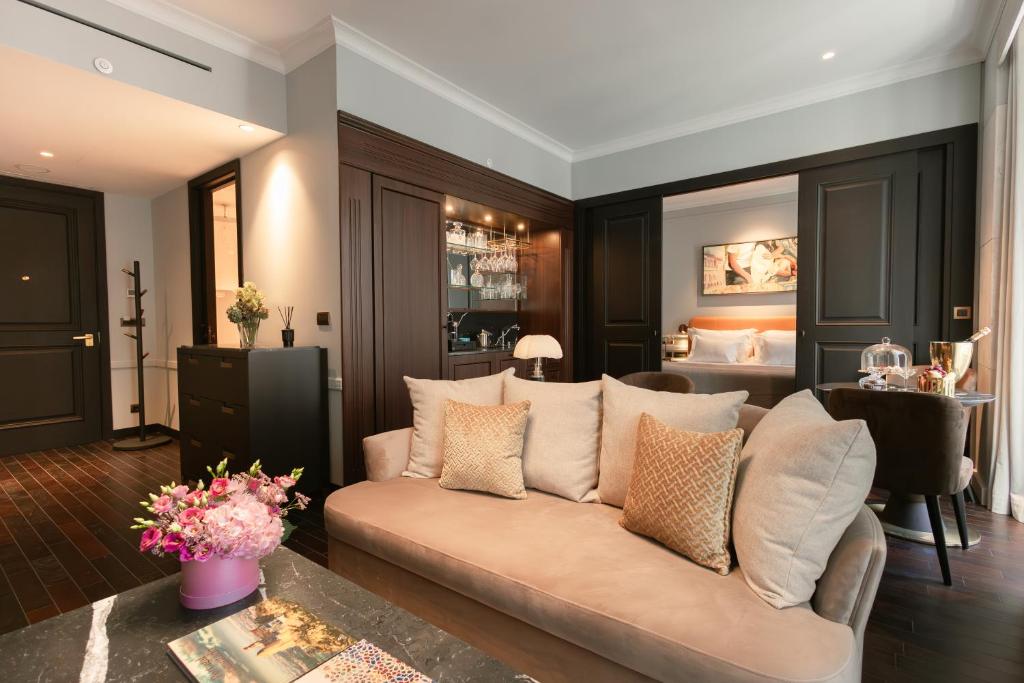 a living room with a couch and a bedroom at MYTHIC SANA Downtown Suites in Lisbon