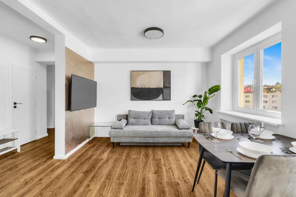 a living room with a couch and a table at Panorama Apartment & Terrace in Bratislava Center in Vinohrady