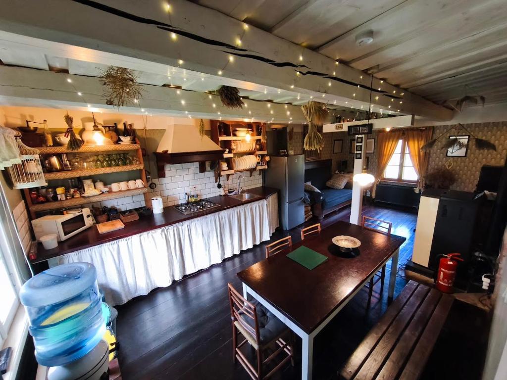 an overhead view of a kitchen with a table and a bar at Vēsturiska viensēta Kārkliņi in Cēsis