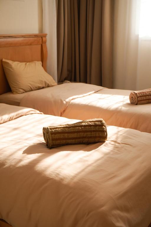 two beds sitting next to each other in a room at Endless Wave Morocco in Agadir