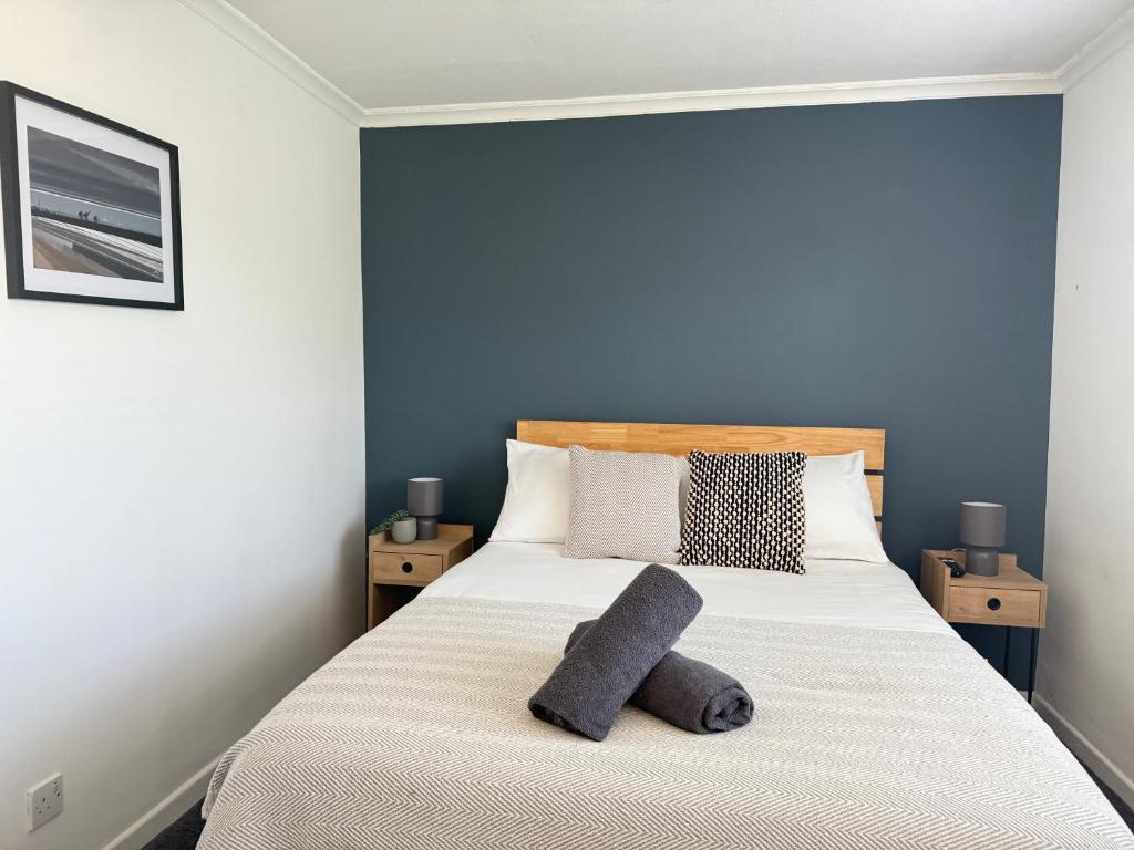 a bedroom with a bed with two pillows on it at 4 Bed House Port Talbot - Perfect For Contractors in Port Talbot