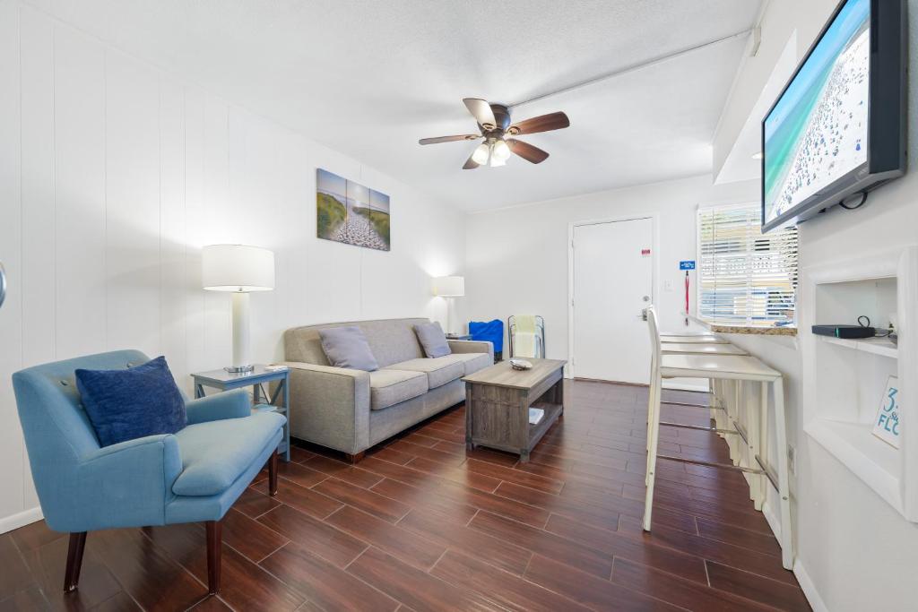 a living room with a couch and a flat screen tv at Sea Club II By Beachside Management in Siesta Key