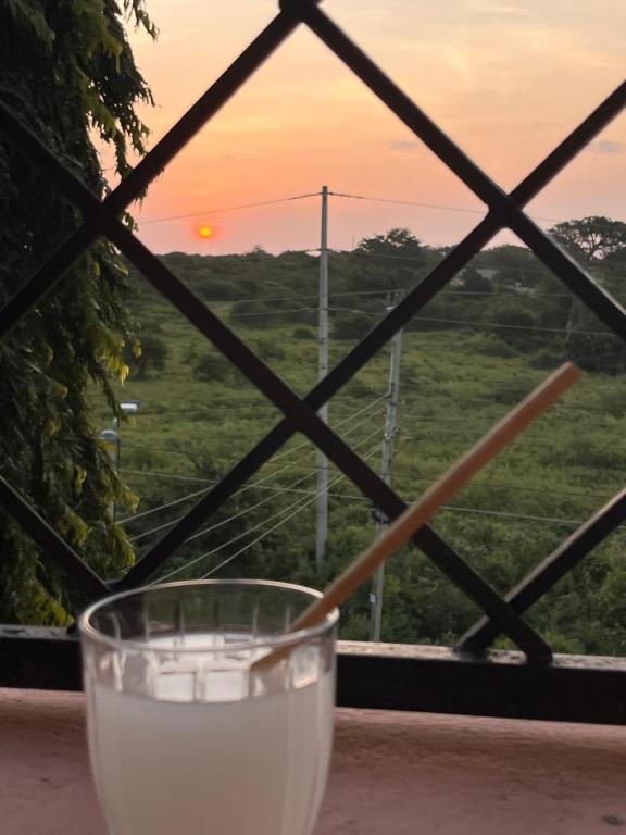 a glass of milk with a view of the sunset at Sunset Hideaway in Kilifi
